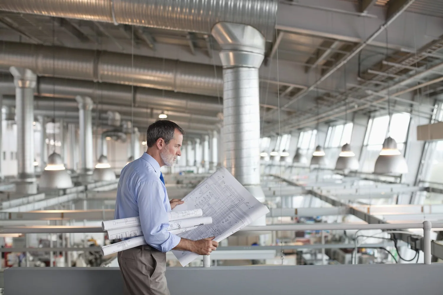 An architect reading drawings in a large building